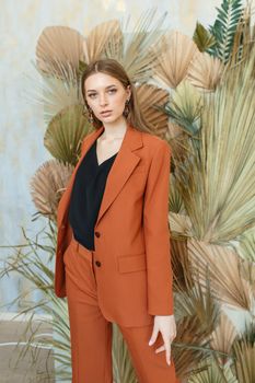 The girl is a model in a brown suit. Shooting clothes for a fashion store.