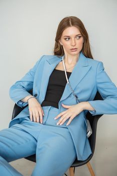 The model is a girl in a blue business suit. Shooting fashionable clothes for the store.