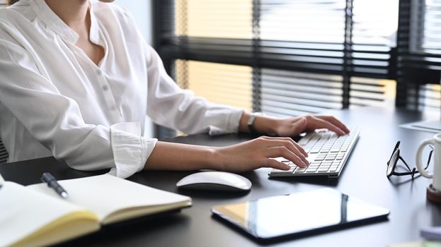 Cropped shot accountant manager working at office with modern devices.