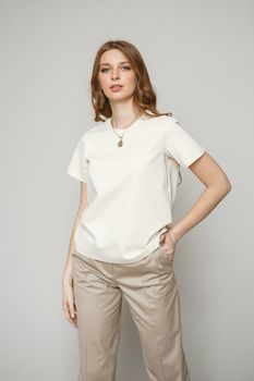 A model in brown casual clothes on a studio background.
