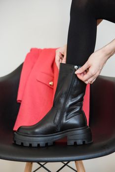 A girl model in pink clothes in the studio. Shooting fashionable clothes for the showroom.