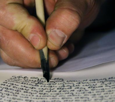 Boy reading Torahjudaism.Torah. A sacred roll which is written in manual