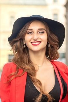 Close up portrait smiling girl wearing hat and posing at the city summer street.