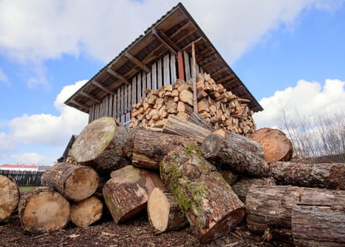 Large rural stack of firewood. Old firewood. Background.