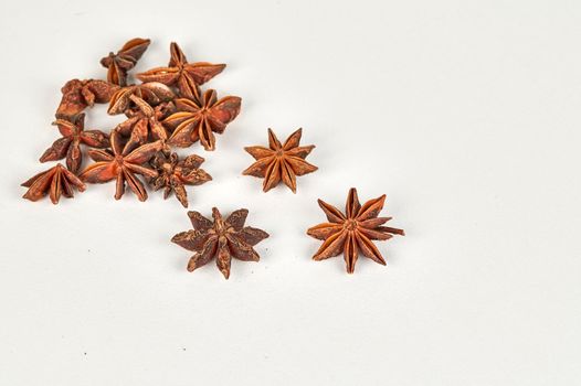 Handful of star anise with selective focus on a white background