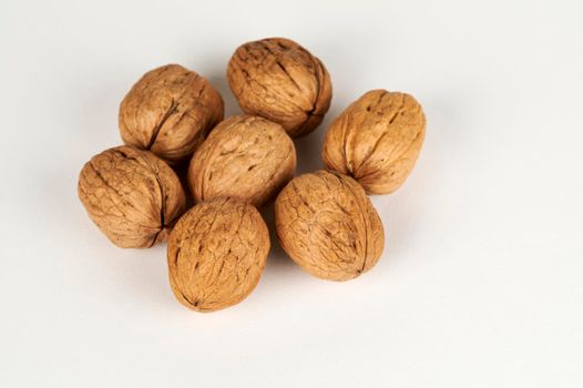 Whole walnuts closeup on a white background