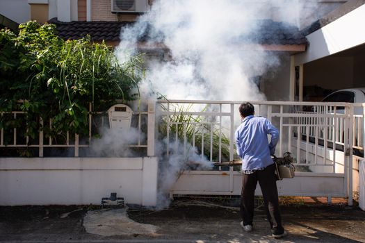 Bangkok, Thailand - November 19, 2016 : Unidentified people fogging DDT spray for mosquito kill and protect by control mosquito is a carrier of Malaria, Encephalitis, Dengue and Zika virus in village.