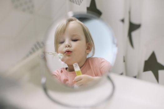 portrait of a toddler girl play in bathroom