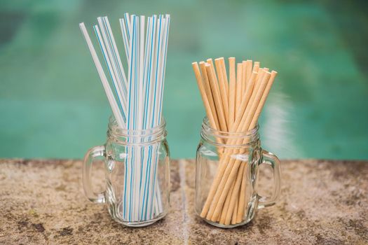 paper and plastic drinking straws on the background of the pool.