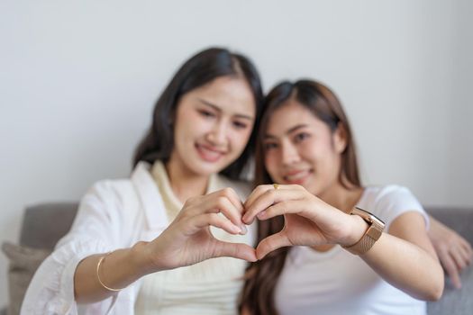 lgbtq, lgbt concept, homosexuality, two Asian women posing happy together and showing love for each other while being together.