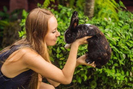 Woman holding a rabbit. Cosmetics test on rabbit animal. Cruelty free and stop animal abuse concept.