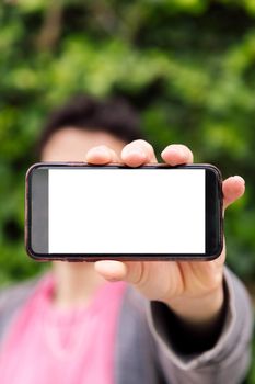 vertical photo of an unrecognizable man showing a smart phone with blank screen, concept of technology, copy space for image or text