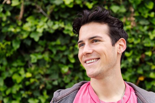 portrait of a joyful young man smiling funny, concept of happiness and teenager lifestyle, copy space for text
