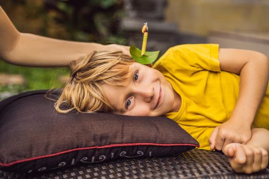 The boy gets a procedure with an ear candle, children's ears health, good hearing, earwax.