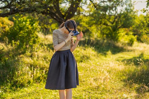 girl with virtual reality gadget in nature