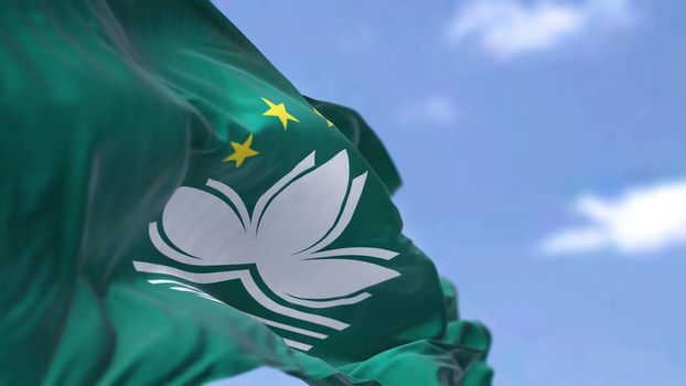 The flag of Macau waving in the wind on a clear day. Macau is a city and special administrative region of China