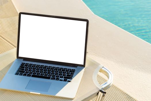 laptop with blank screen near the pool.