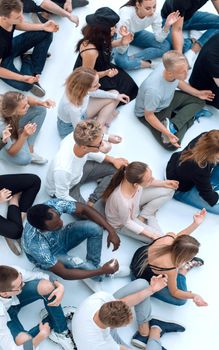 top view. casual group of young people meditating sitting on the floor.