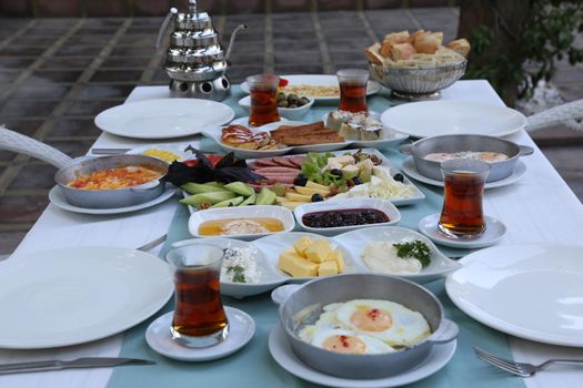 Organic, fresh traditional turkish village breakfast on wooden table with copper egg pan