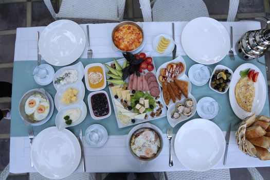 Organic, fresh traditional turkish village breakfast on wooden table with copper egg pan