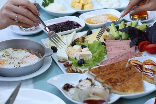 Organic, fresh traditional turkish village breakfast on wooden table with copper egg pan