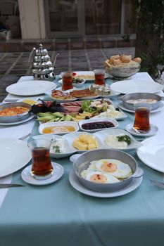 Organic, fresh traditional turkish village breakfast on wooden table with copper egg pan