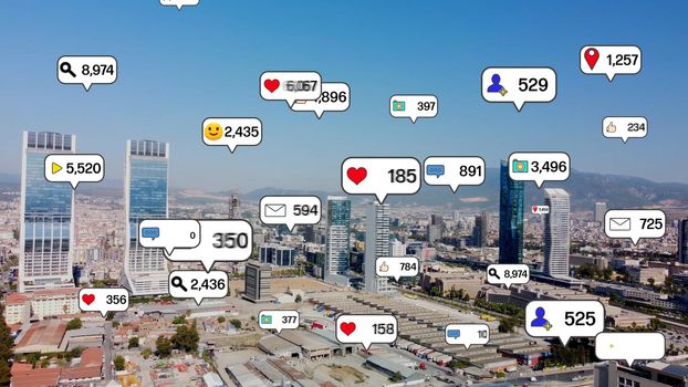 Social media icons fly over city downtown showing people engagement connection through social network application platform . Concept for online community and social media marketing strategy . High quality photo