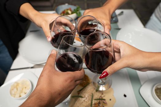 Top view shot of group of people toasting with wine glasses, Summer holiday party