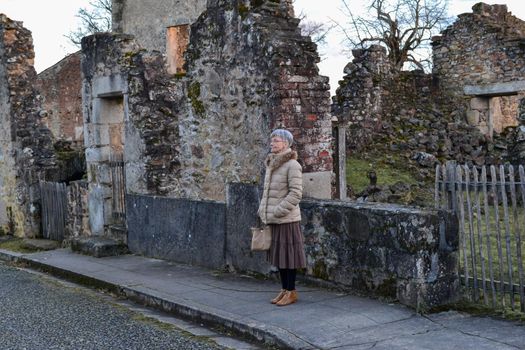A woman near destroyed building during World War 2 in Oradour sur Glane France
