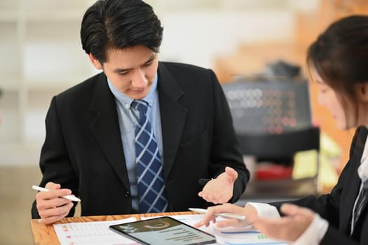 Businesspeople having business conversation for project strategy together in modern workplace.