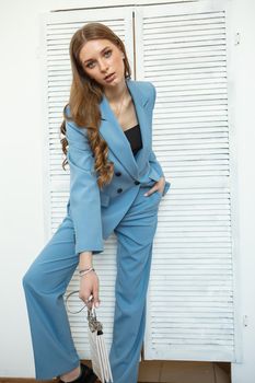The model is a girl in a blue business suit. Shooting fashionable clothes for the store.