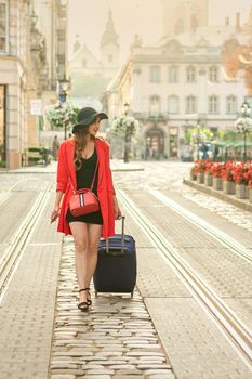 Tourist young woman traveling on the tram track road of the old city street.