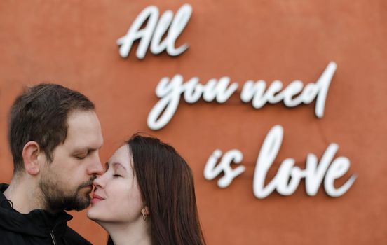 Young happy couple in love. All you need is love message.