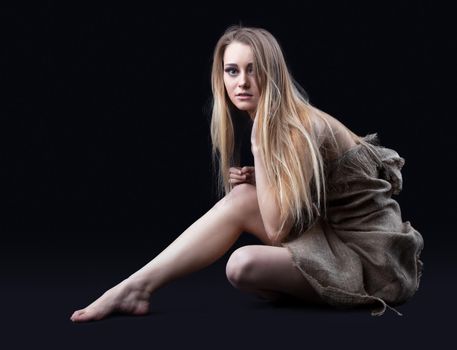 naked young girl with blond hair in rag sit