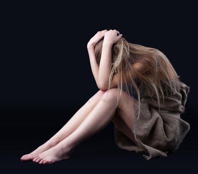 Beauty blond girl in rag close head in depression
