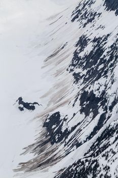 Abstract Aerial view of the glacier ice on the side of the mountain. Taken in remote part of British Columbia, Canada. Clendinning Provincial Park.