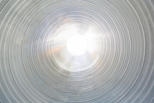 The ventilation pipe is round from the inside. Steel pipes, parts for the construction of industrial air conditioning ducts inside the pipe. Industrial ventilation equipment