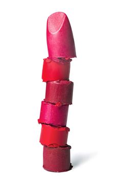 Cut lipstick pieces stacked together isolated on a white background