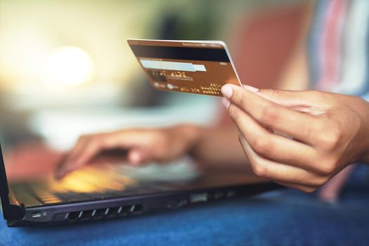 Cropped shot of a beautiful African woman doing online payment