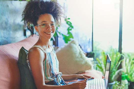 Shot of a beautiful African woman doing online payment