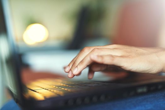 Shot of an unrecognizable woman using a laptop on the sofa at home stock photo