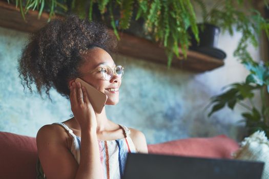 Attractive African woman working from her living room