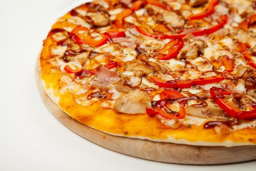 Delicious pizza with bacon and chicken Teriyaki served on a wooden plate, ingredients Signature sauce, mozzarella cheese, Teriyaki chicken, bacon, Bulgarian pepper, Teriyaki sauce on white