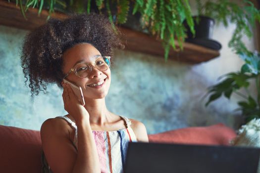 Attractive African woman working from her living room