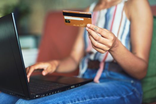 Cropped shot of a beautiful African woman doing online payment