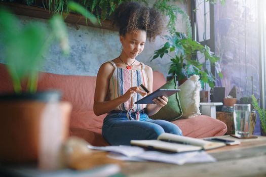 Shot of a beautiful African woman working from home