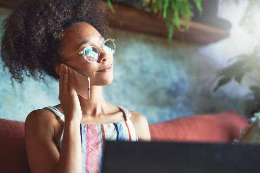 Attractive African woman working from her living room