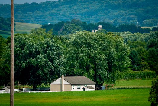 An Amish One Room School House in the Middle of Rich Farmlands on a Sunny Summer Day