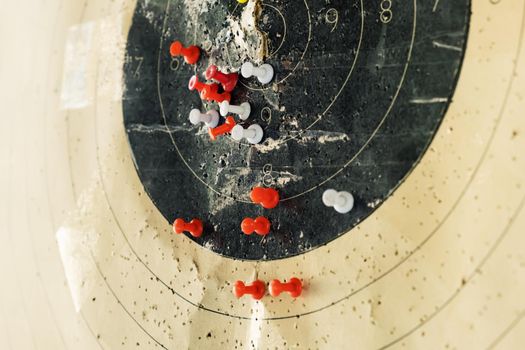 The target is marked with pins. Colored pins indicate on the target in the dash the shooters hit from the weapon