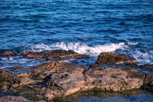Beauty sunny day view of sea waves with rocks
